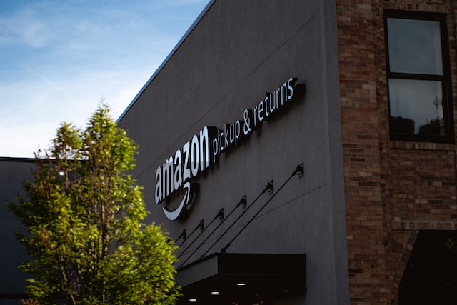 The front of a grey building with an Amazon sign.